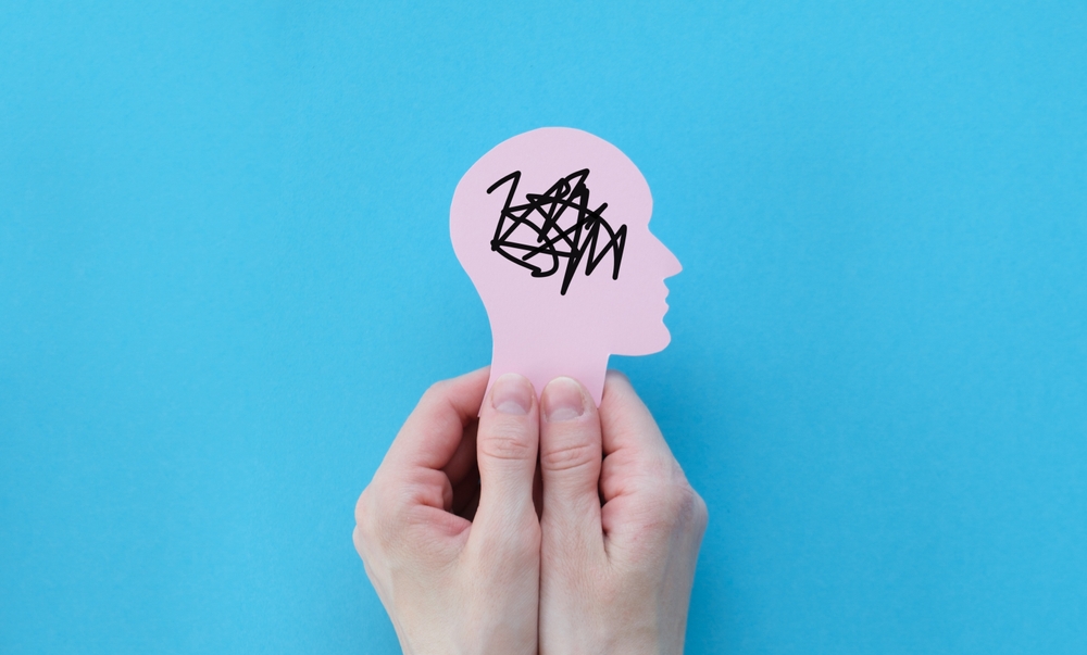 Hands holding human head, confused mind